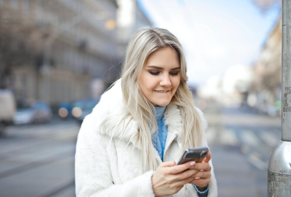 a girl in a city using smart phone