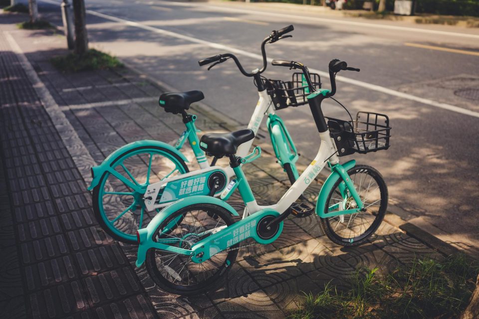 shared bikes parked on the roadside pavement