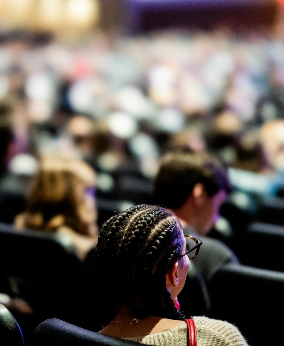 woman on seat in auditorium