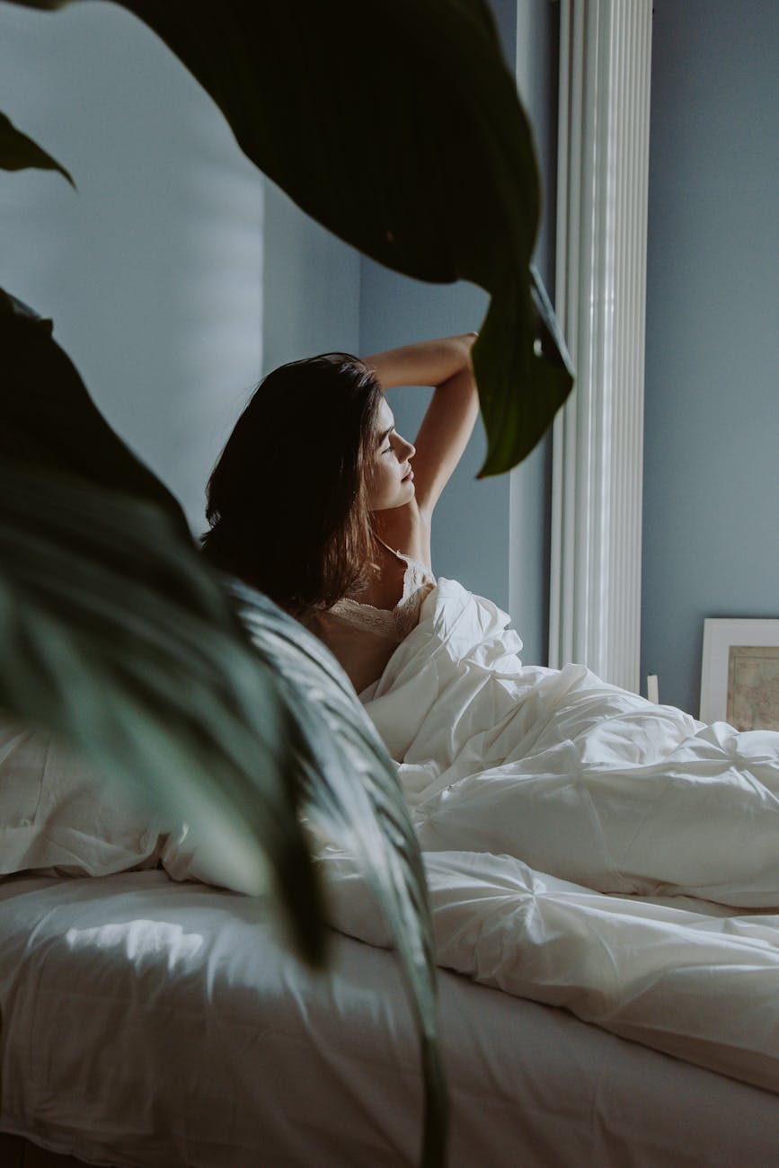 a woman waking up on a bedroom