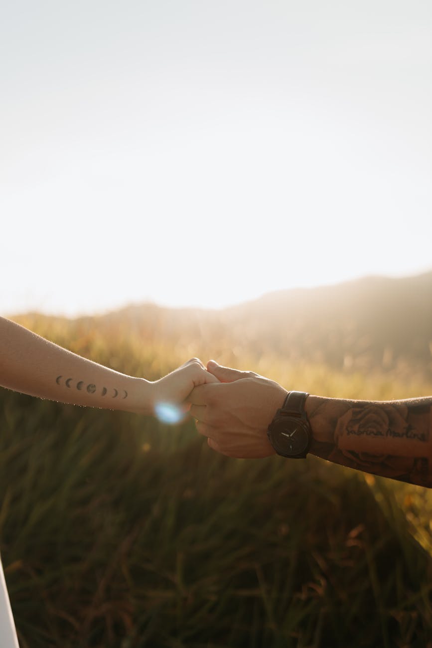 romantic outdoor couple holding hands at sunset