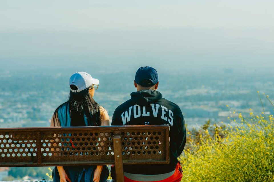 young couple enjoying scenic city view from hilltop