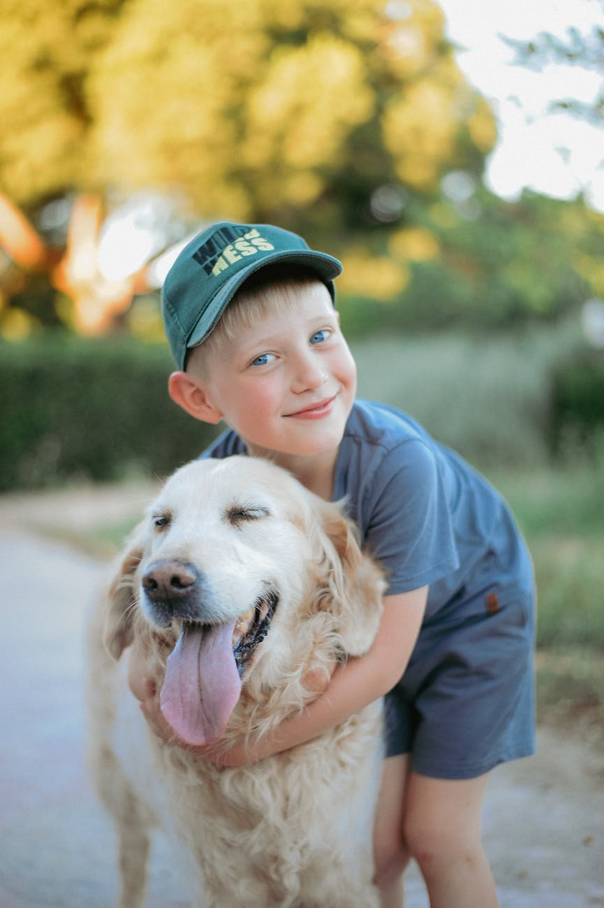 a little boy hugging his golden retriever dog