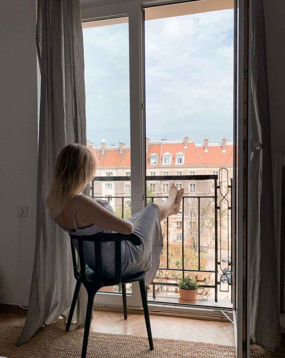 woman wearing spaghetti strap dress sitting on chair