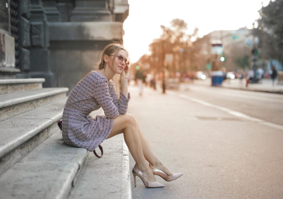 woman in long sleeve dress sitting on the stairs