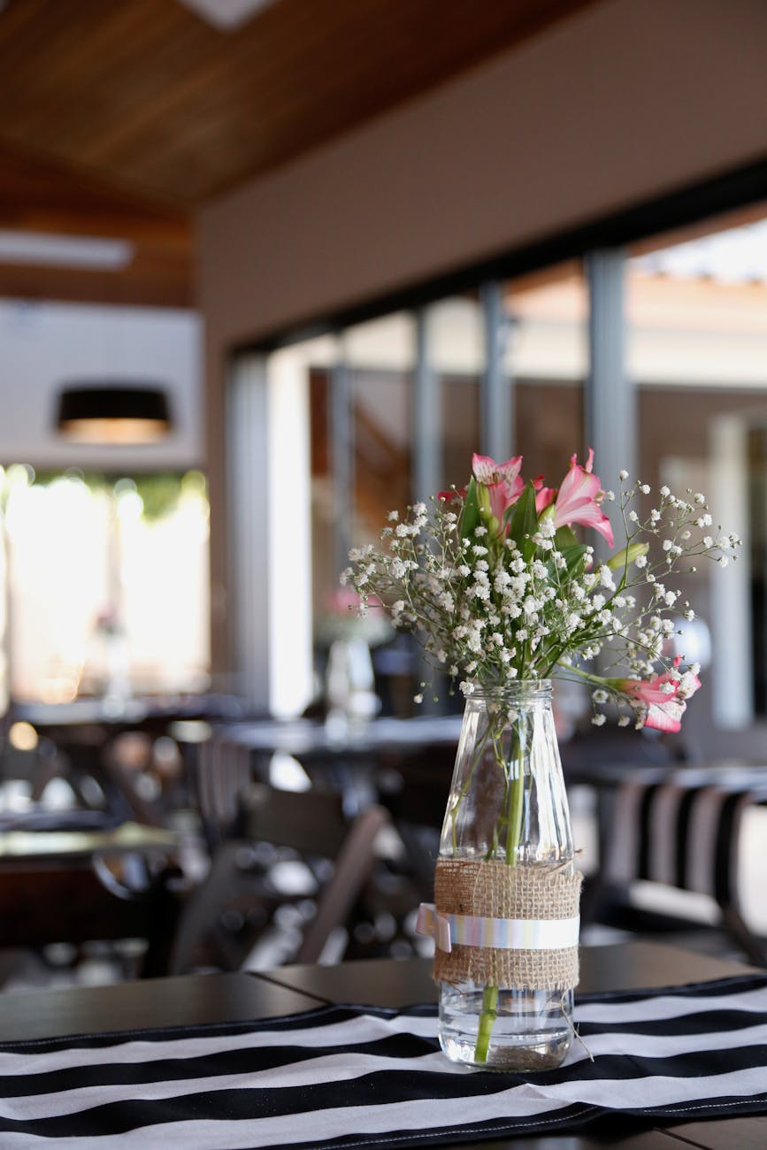 pink and white flowers on clear glass vase