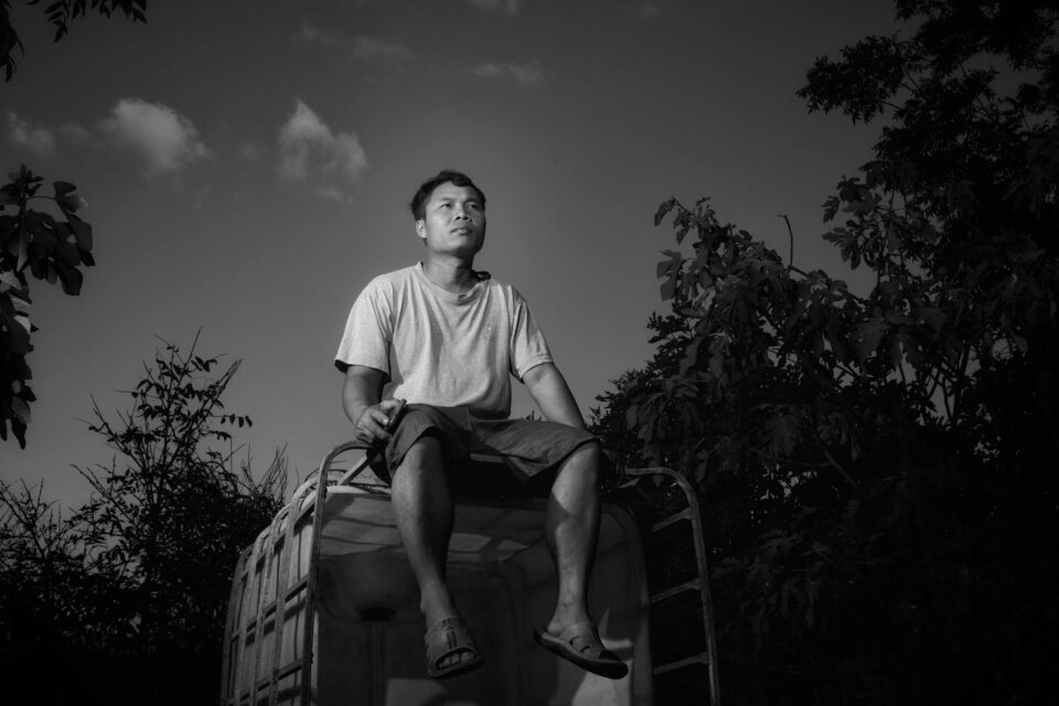 contemplative man sitting outdoors in sunset