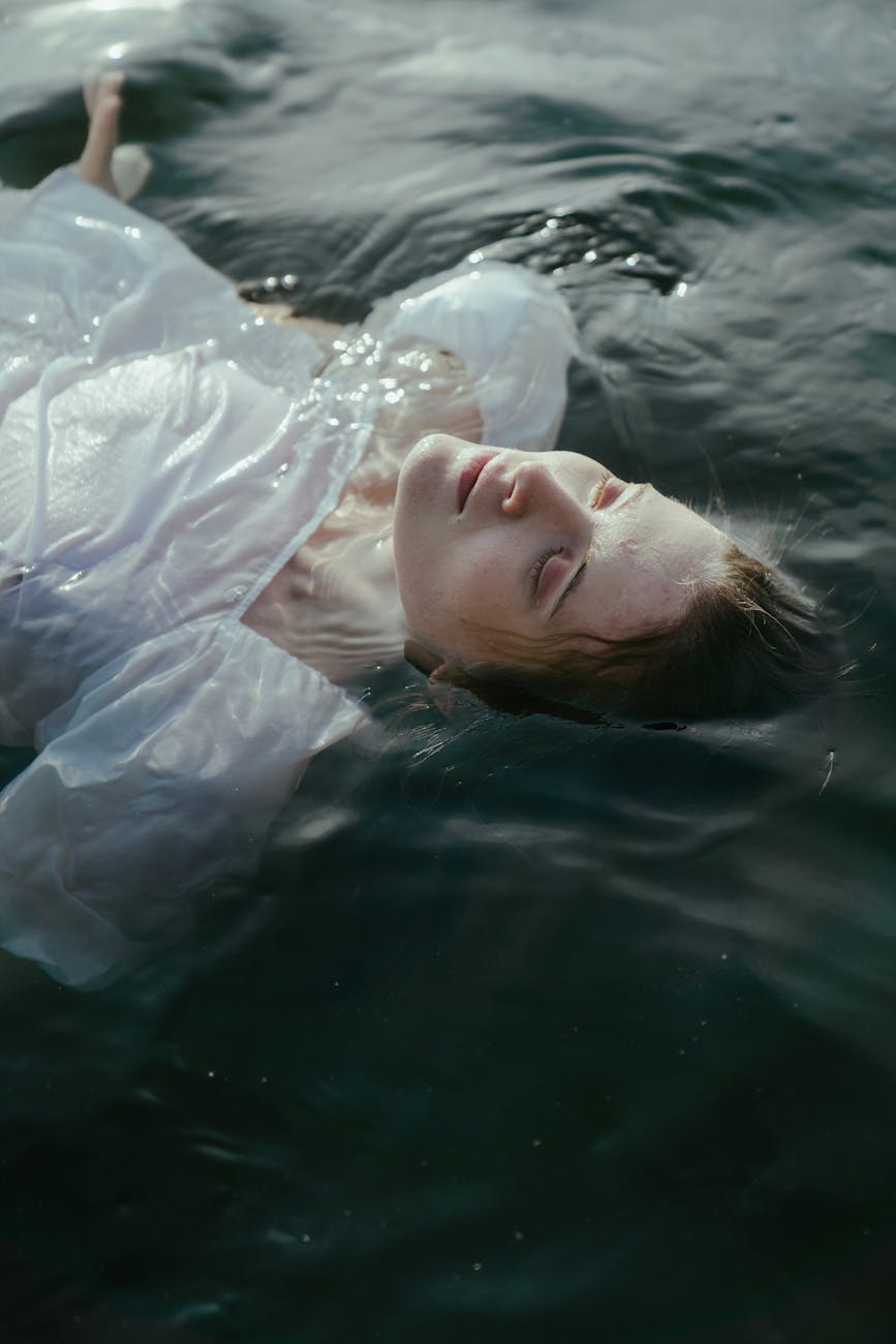 photo of a woman floating in a lake