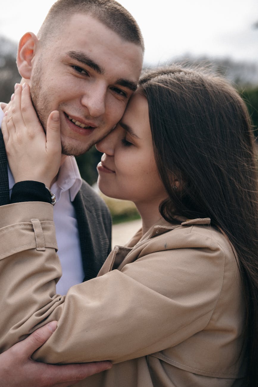crop smiling couple embracing on street in daytime