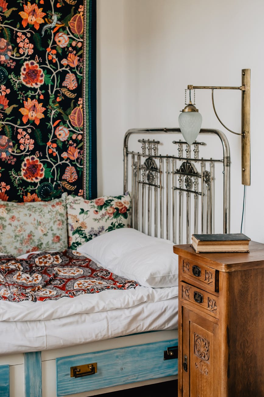 vintage bedroom with floral decor and antique bedframe
