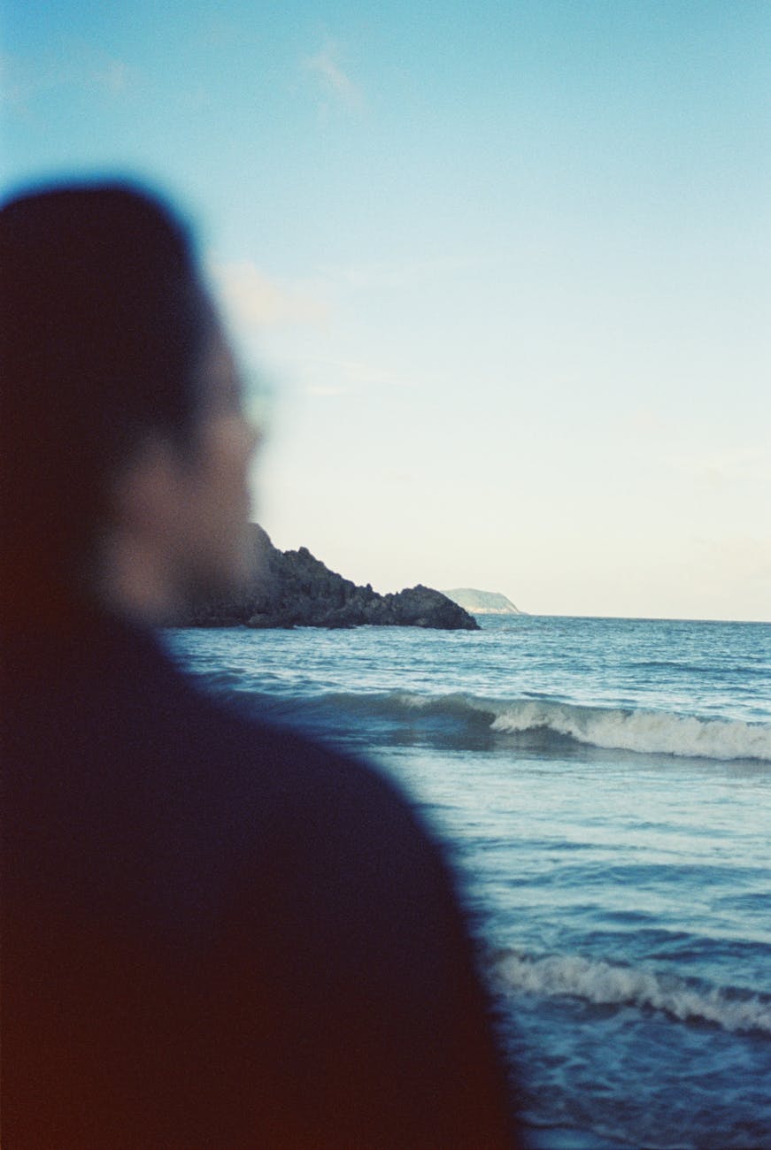 wave on calm seashore in front of person
