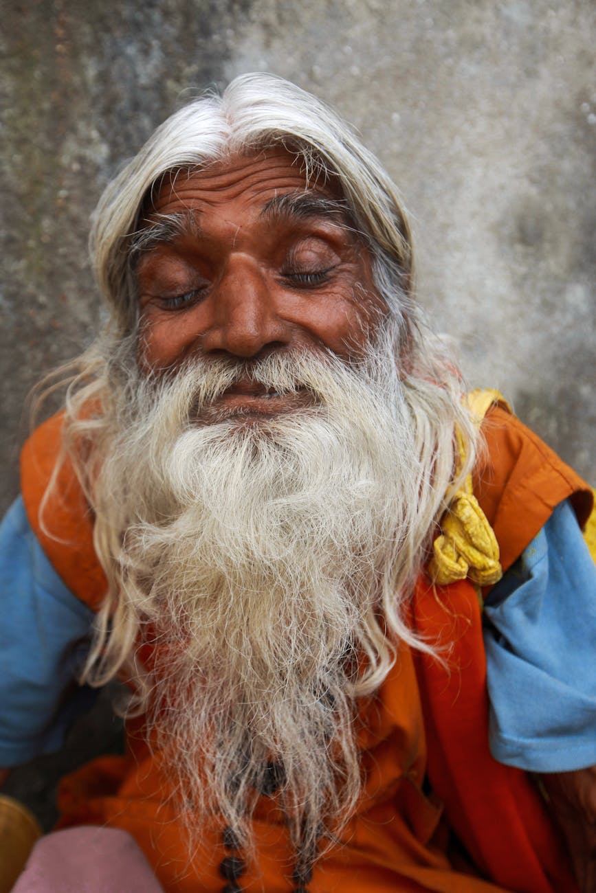elderly man with beard while eyes closed