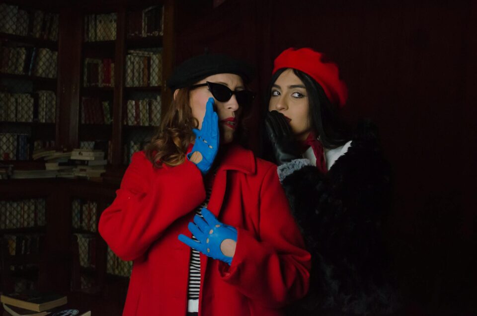 stylish women whispering in a library setting