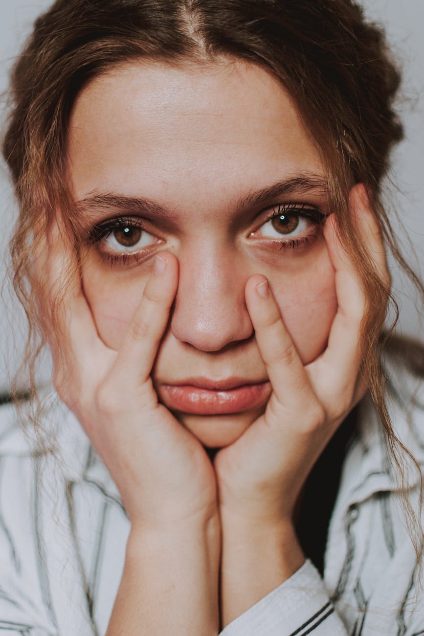 stressful woman touching face at home
