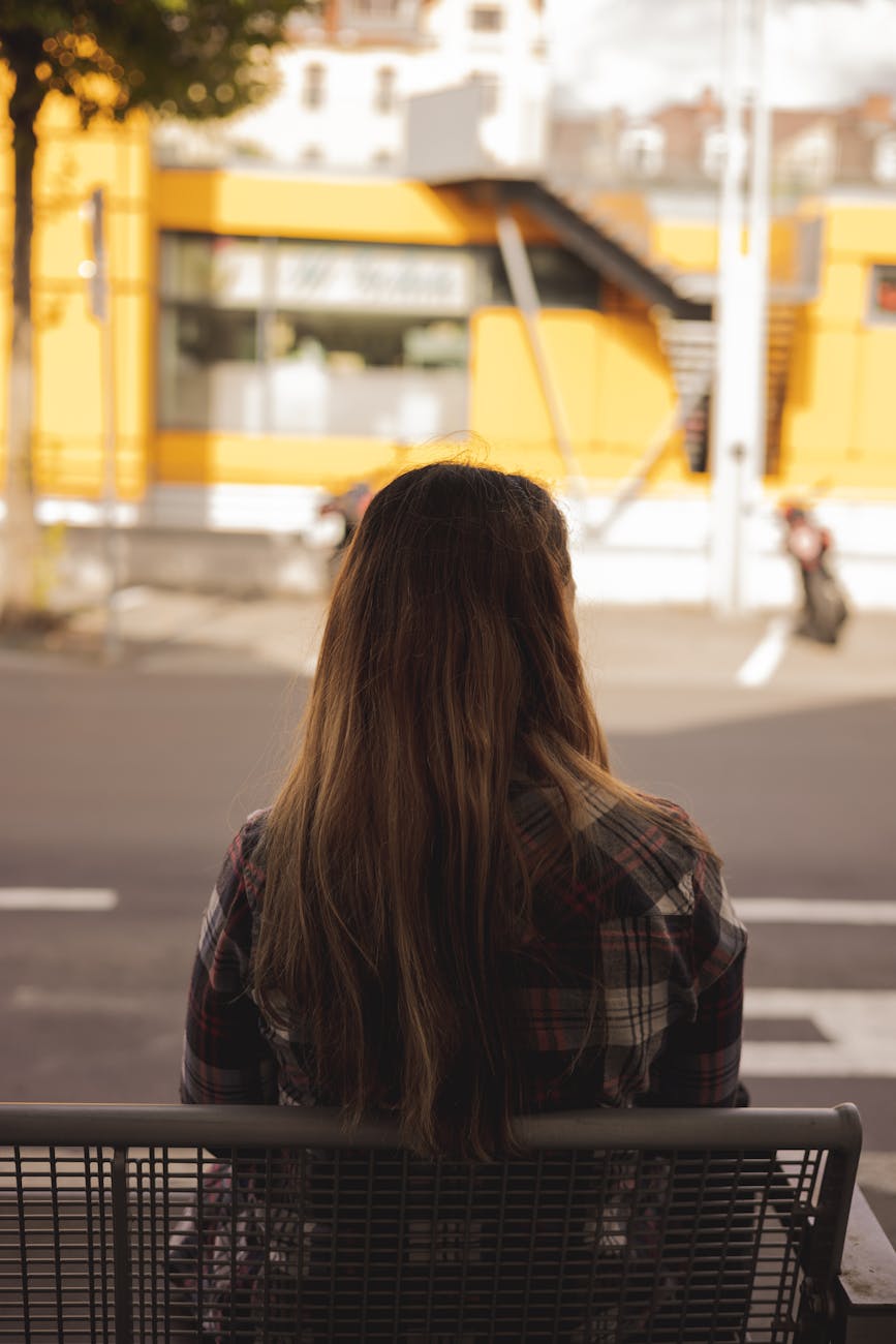 woman sitting on a bench in a city