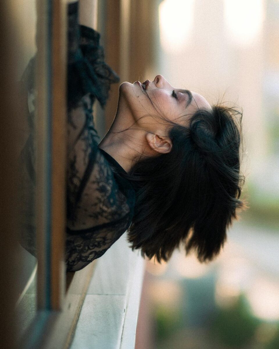 stylish woman leaning out window in istanbul