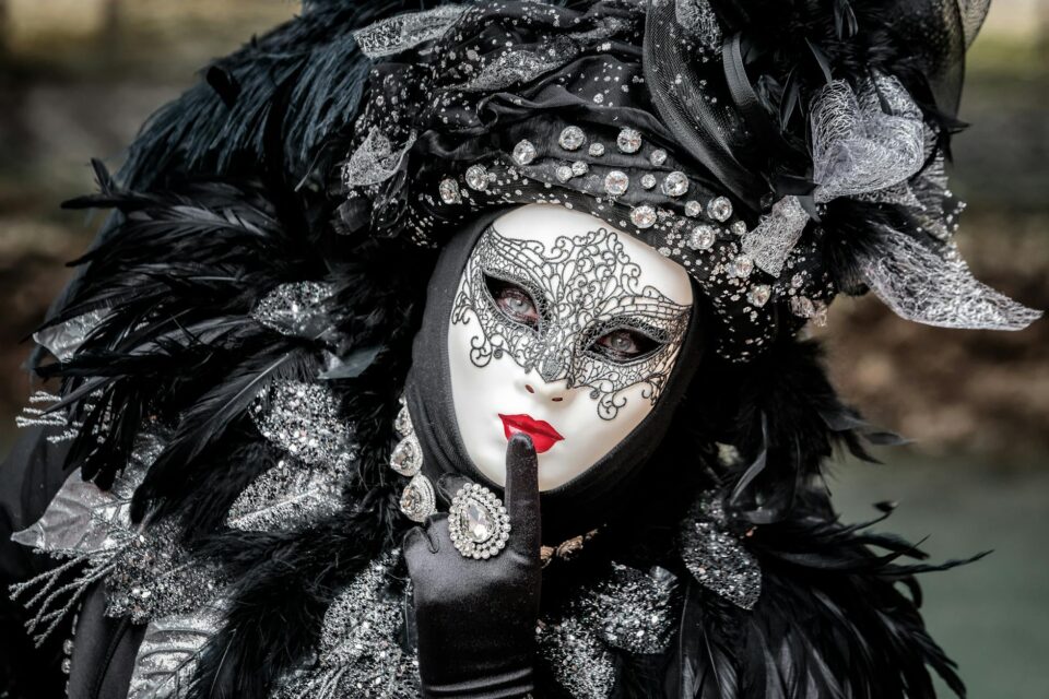 portrait of a person wearing a mask and a costume during a traditional festival