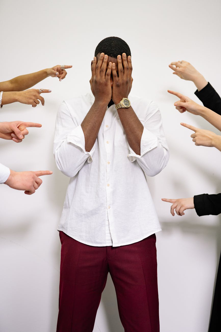 a man covering his face