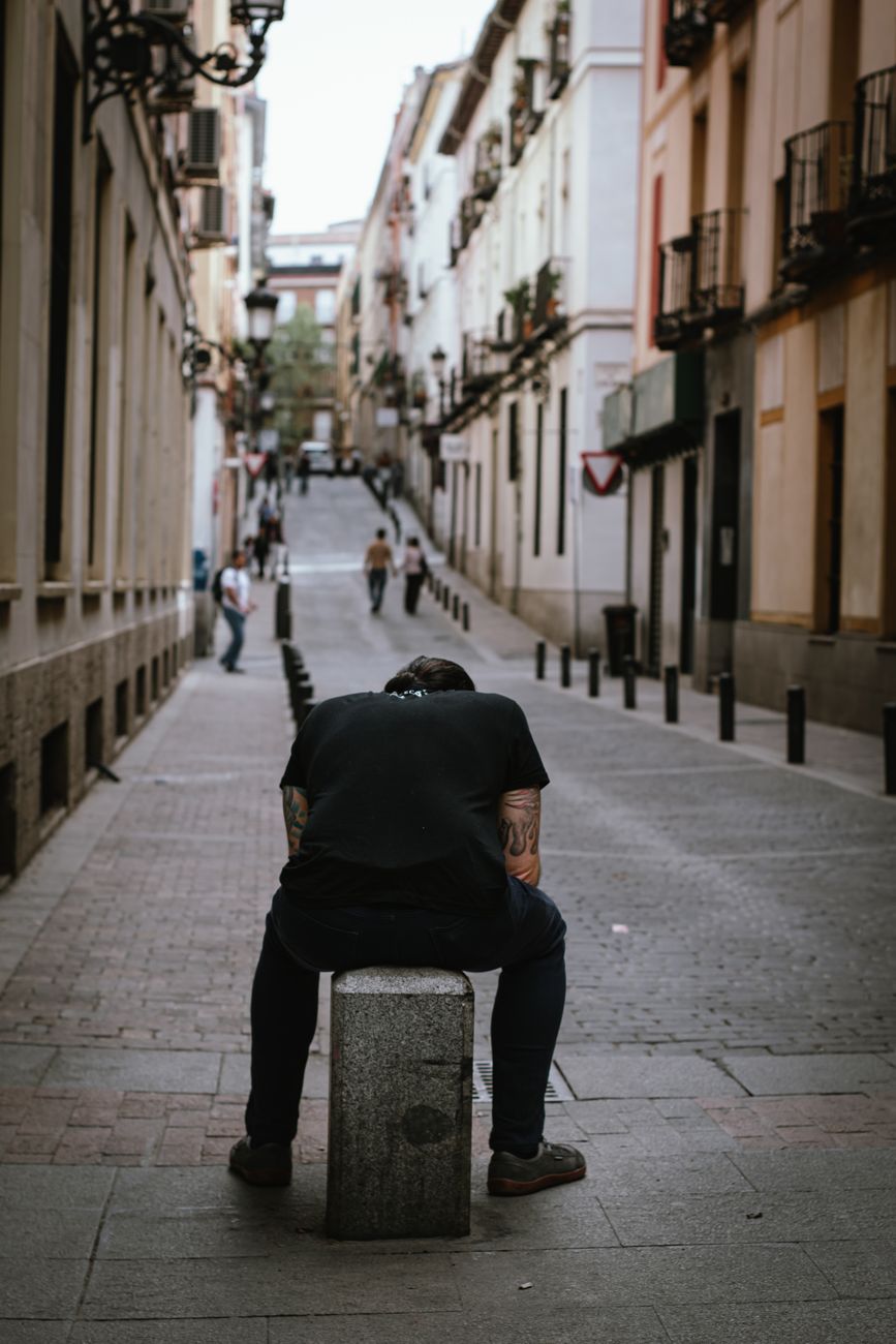 man sitting alone on a madrid street