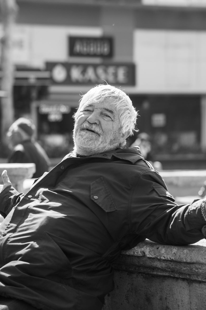 candid black and white portrait of relaxed man outdoors