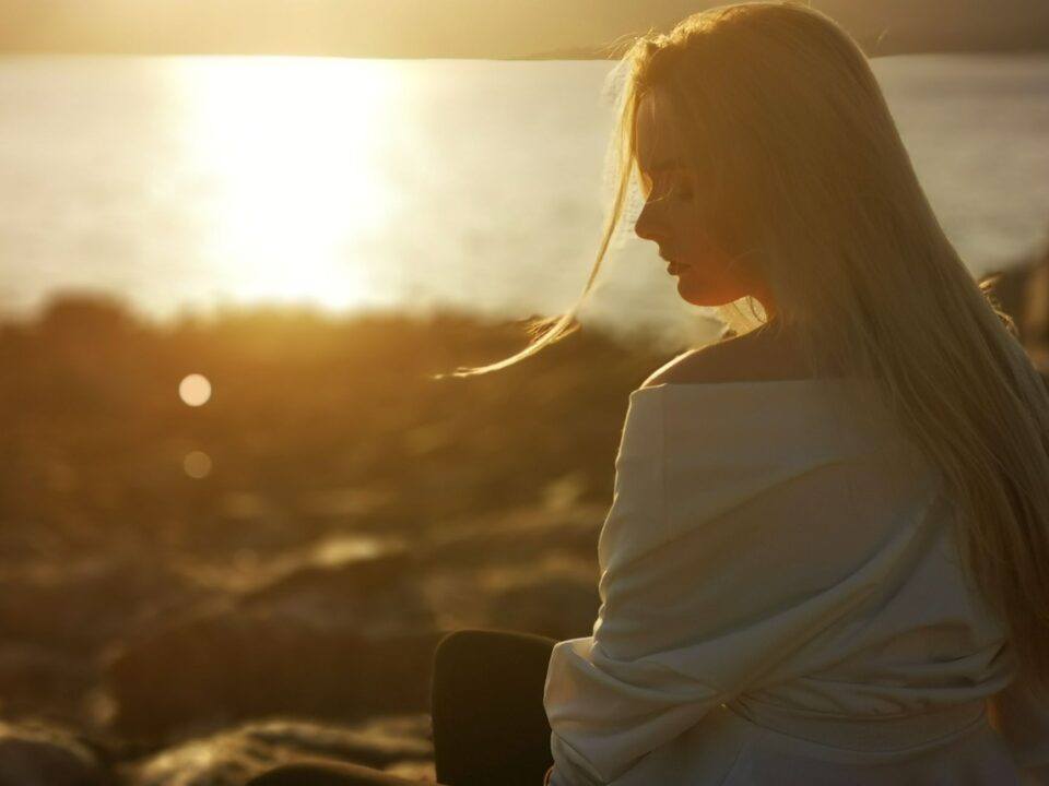 a woman in white top looking on the side