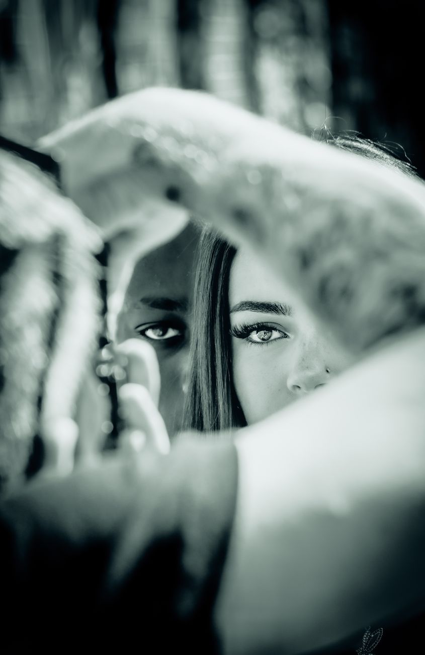 a woman is looking at her reflection in a mirror