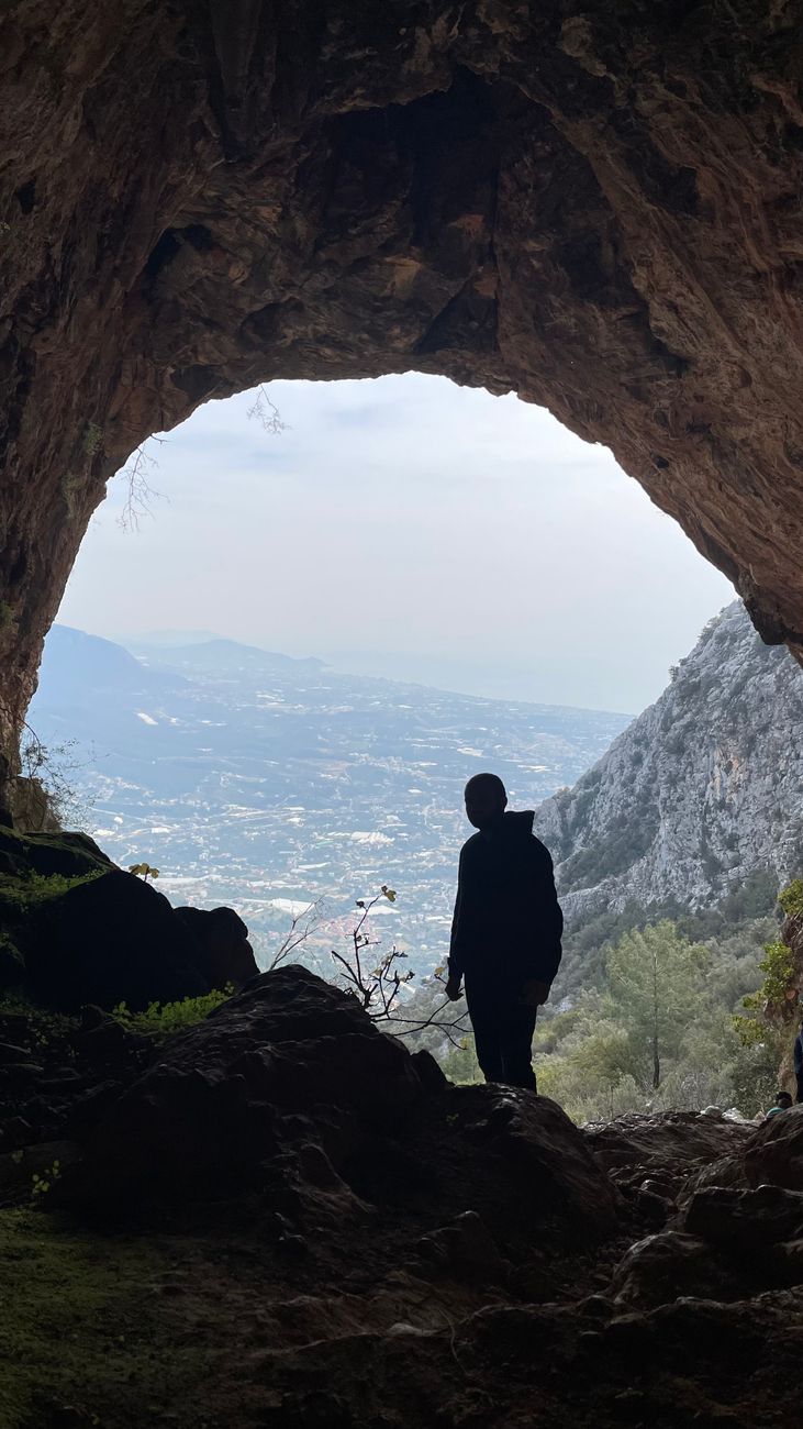 man standing in cave entrance