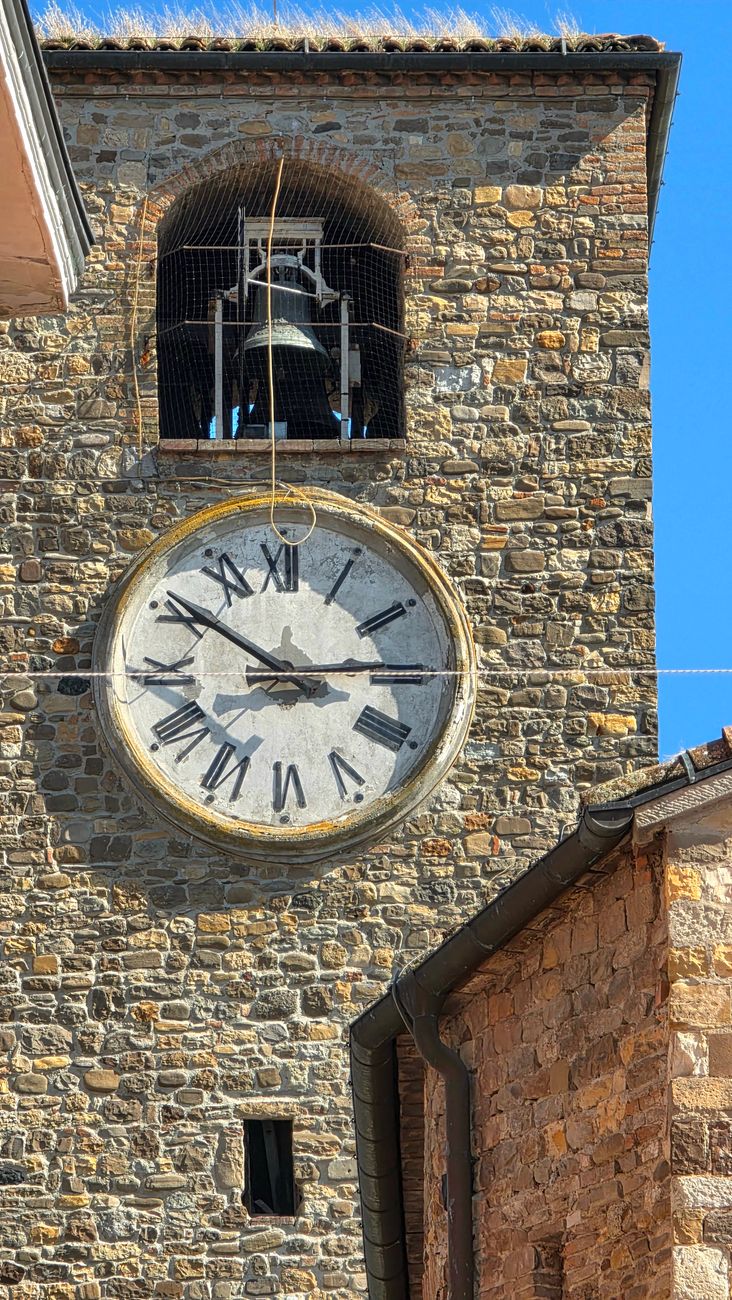historic stone clock tower with roman numerals